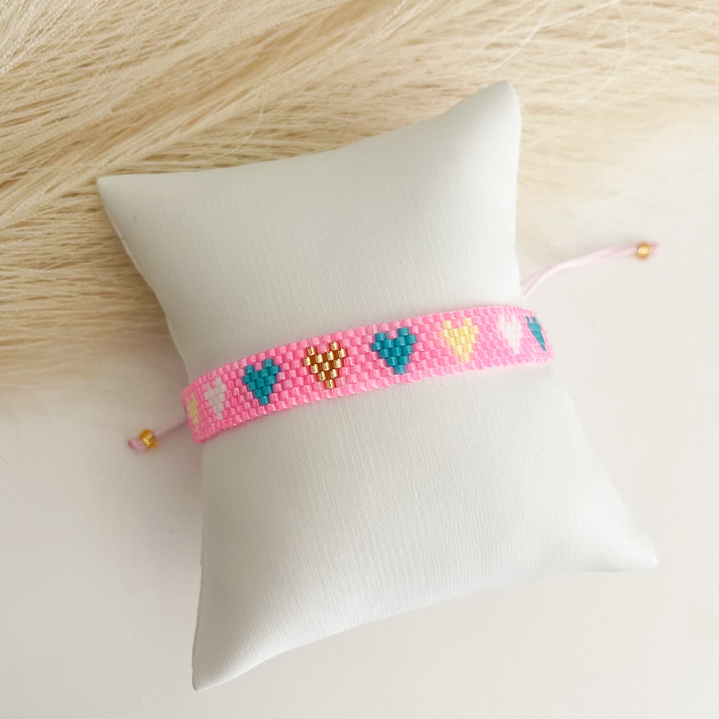 Pink bracelet with colors hearts