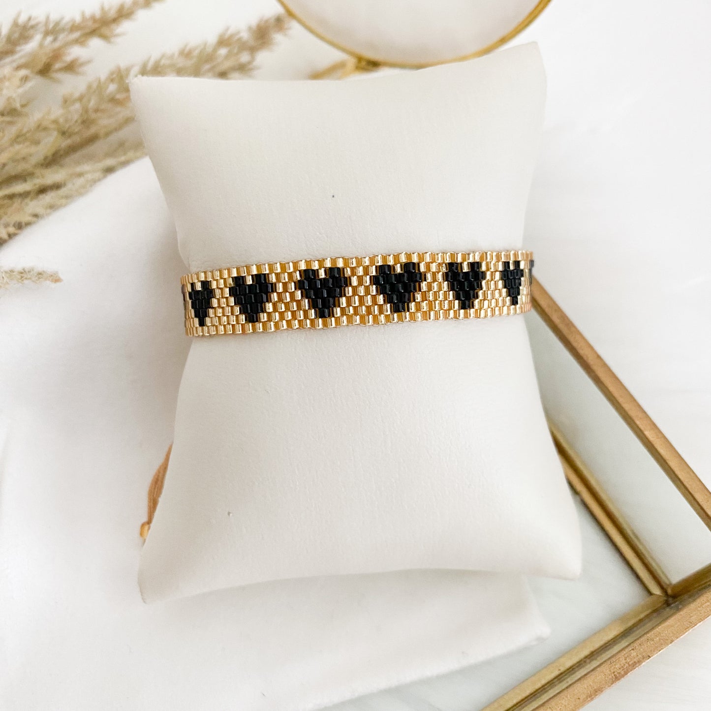 Gold bracelet with black hearts