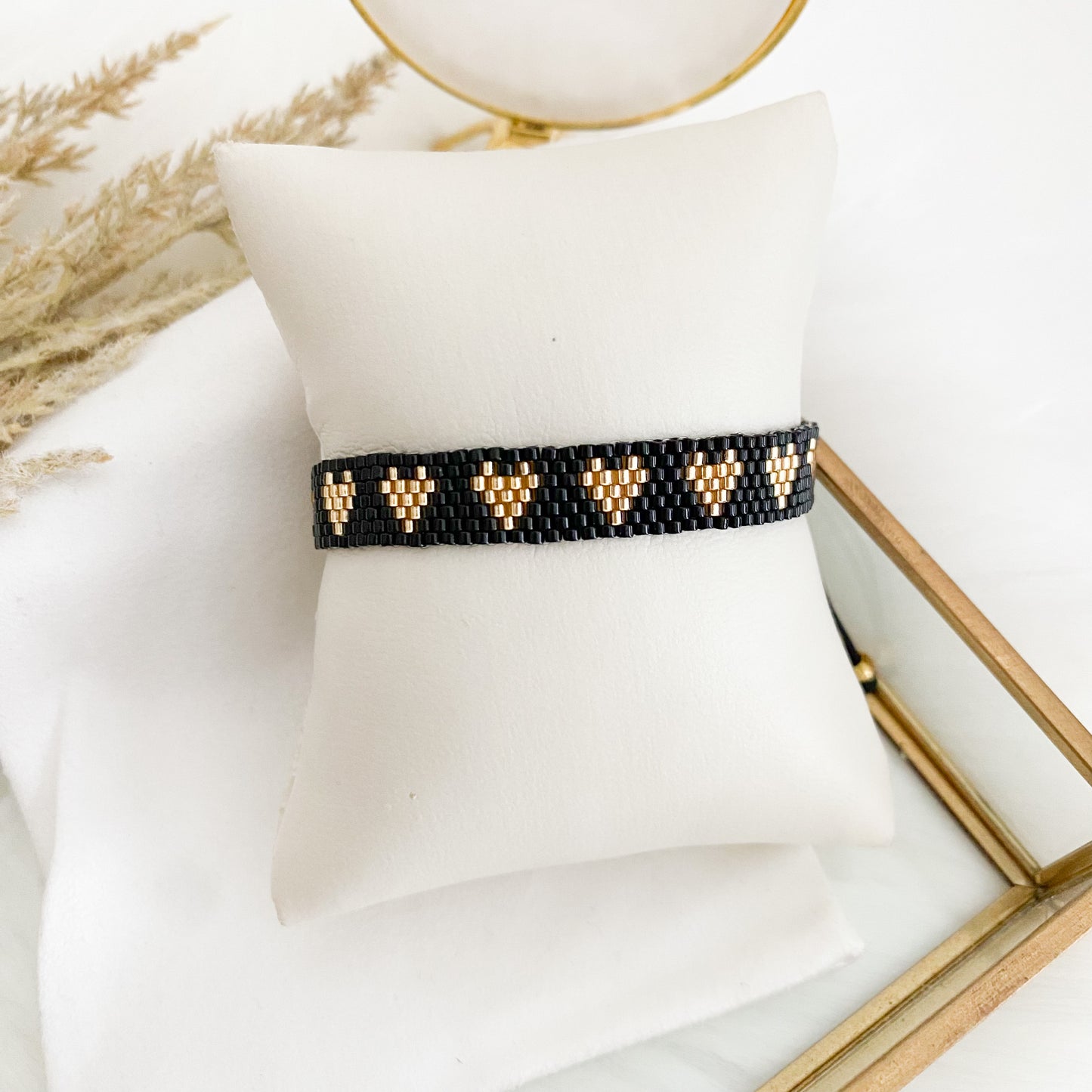 Black bracelet with gold hearts