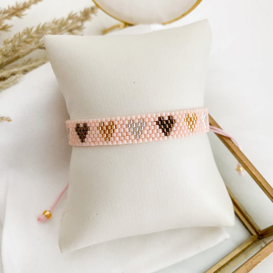 Nude pink bracelet with brown hearts