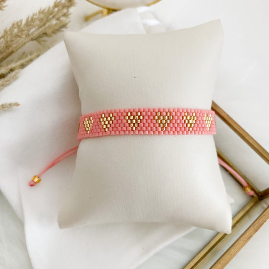 Pink bracelet with gold hearts