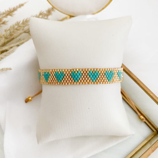 Gold bracelet with turquoise hearts