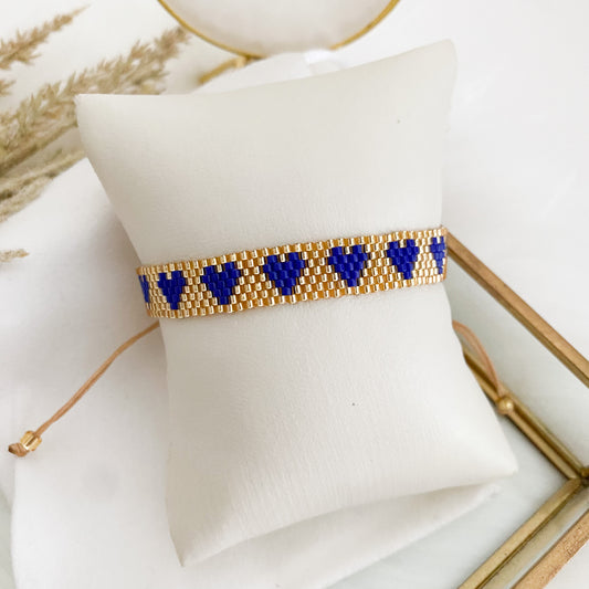 Golden bracelet with royal blue hearts