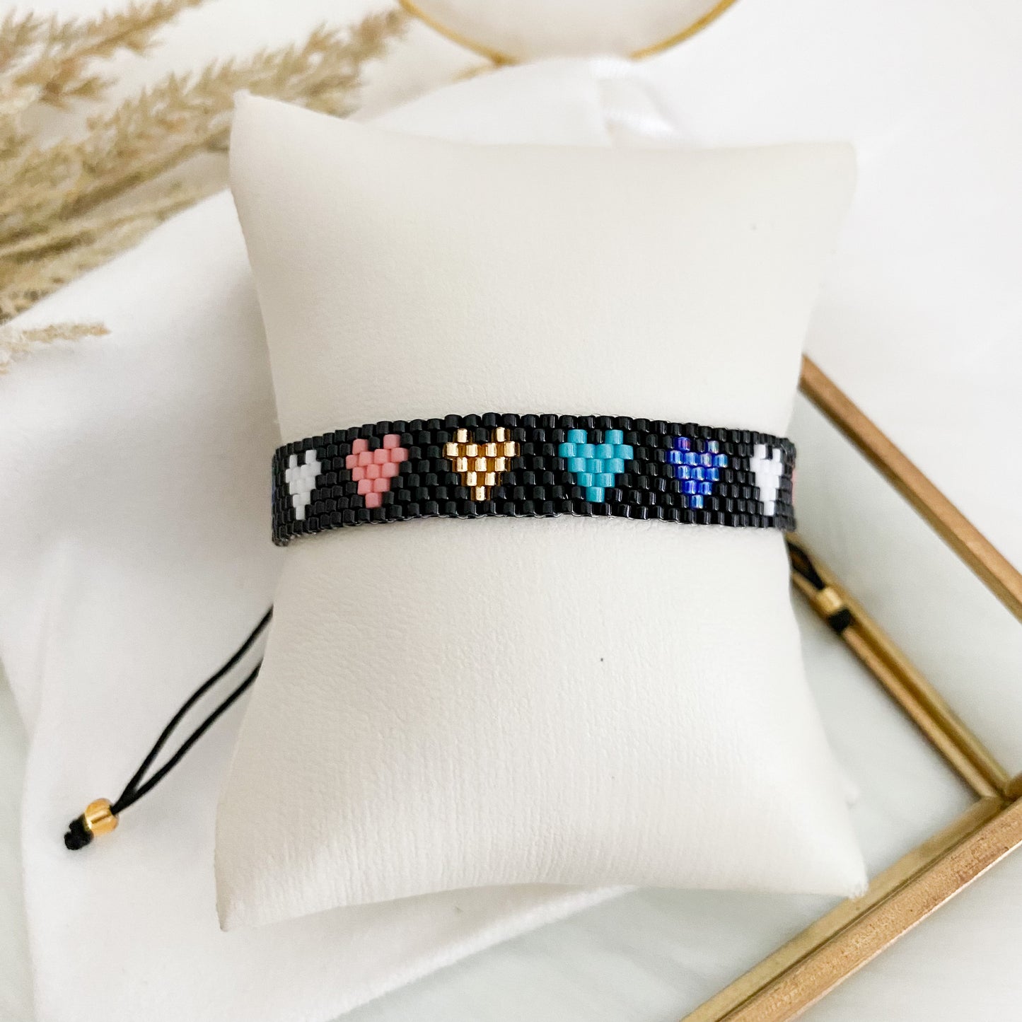 Black bracelet with colorful hearts